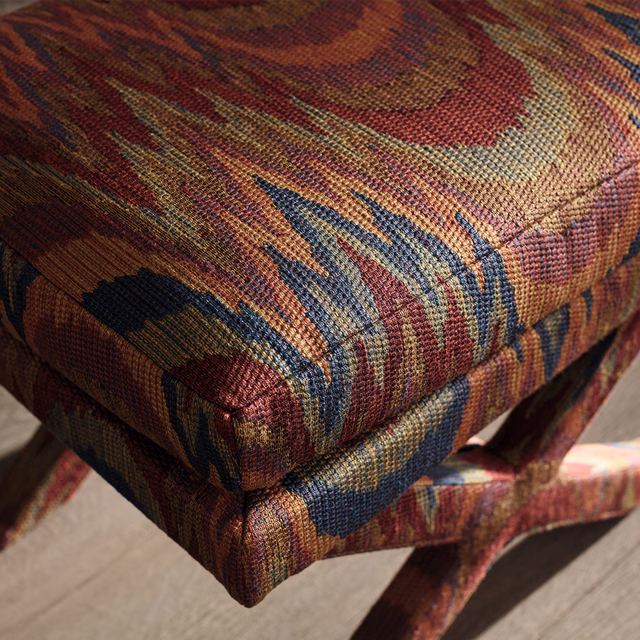 Rust, ochre, blue and burgundy abstract woven upholstery on stacked cushions