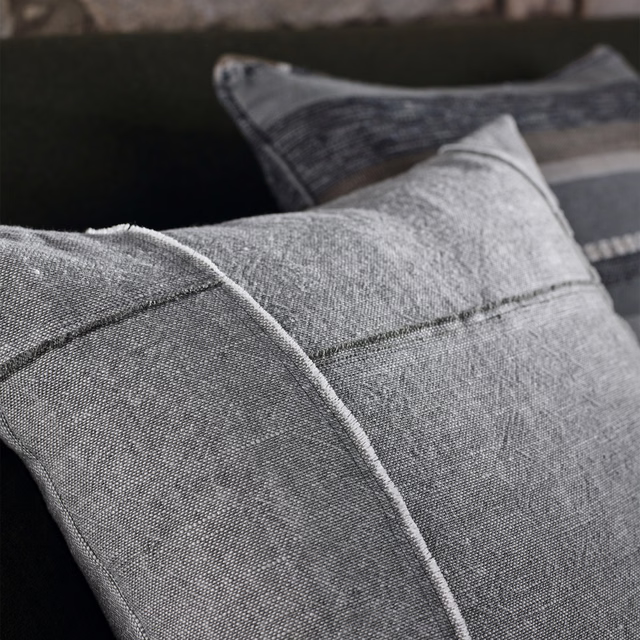 Cool smoke-grey woven fabric on tailored cushions with fine marl texture