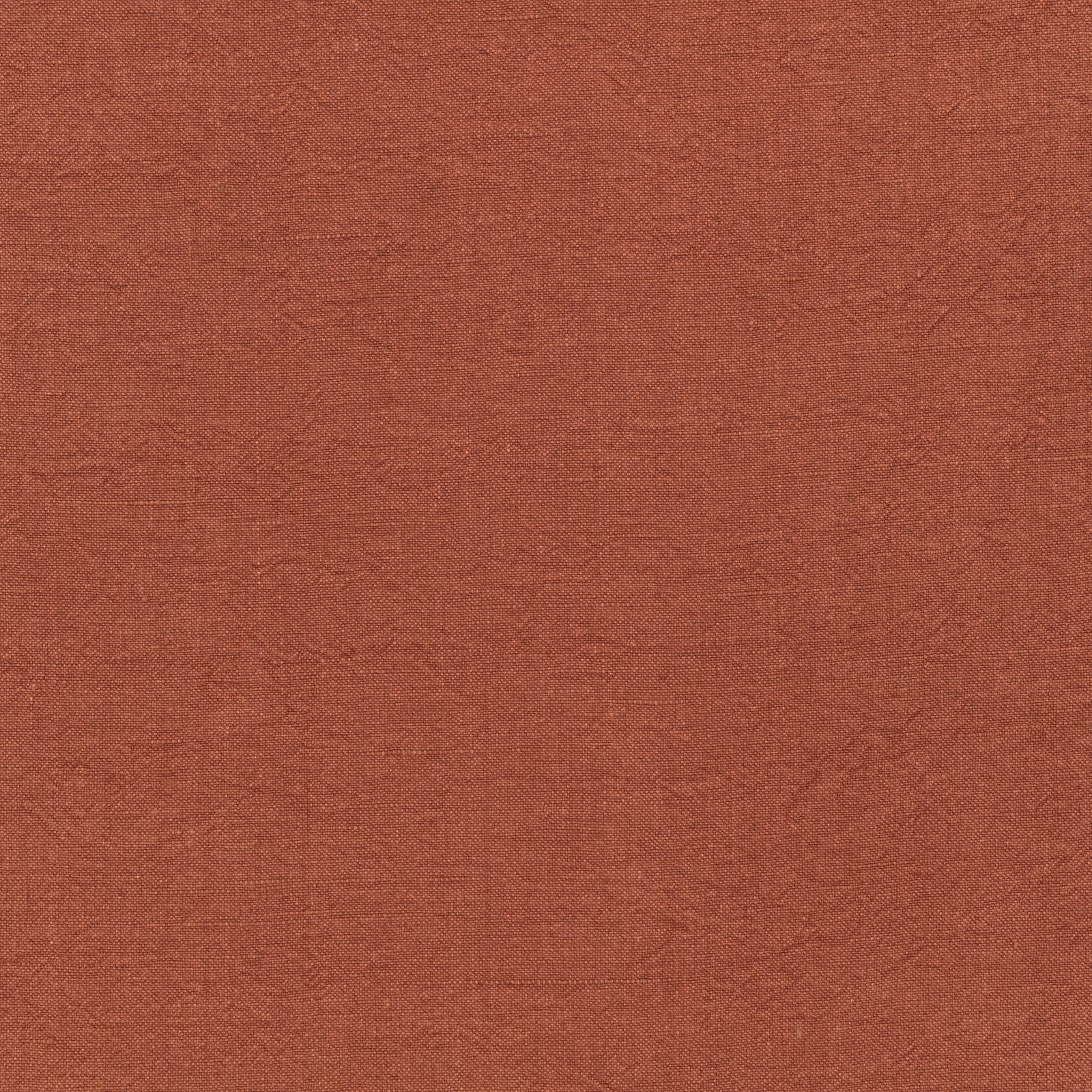 Close-up of warm terracotta-brown woven textile with subtle tonal mottling