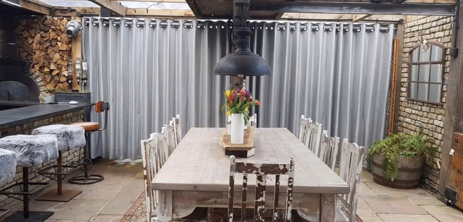 Outdoor eyelet curtains in a garden room