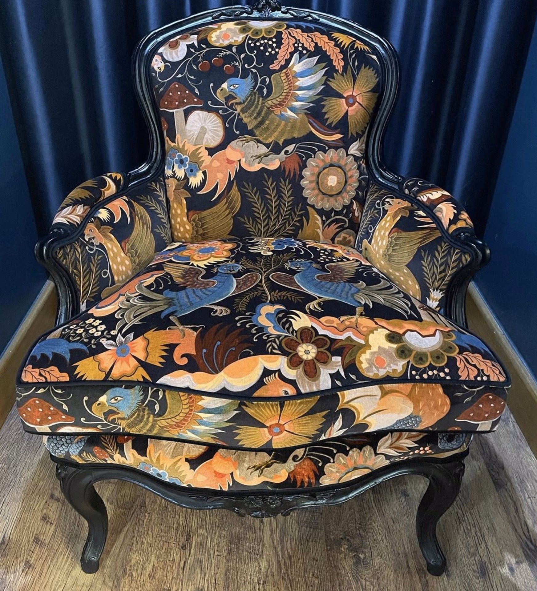 A carved chair upholstered in the workshop