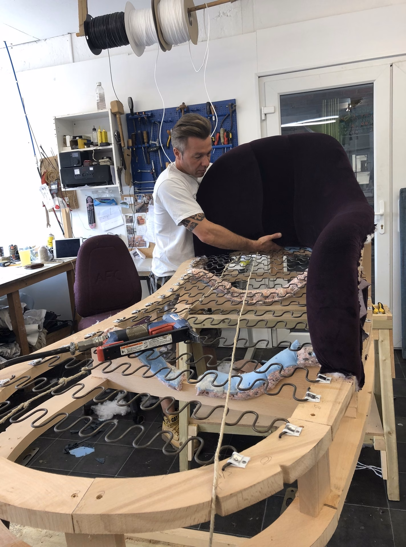 The frame of a chaise being built in the workshop